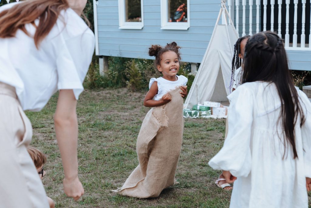 A little girl participates in a sack race at a Brave-themed birthday party